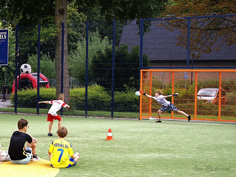 Kinderen aan het voetballen tijdens de penalty party op Johan Cruijff court in Dronten